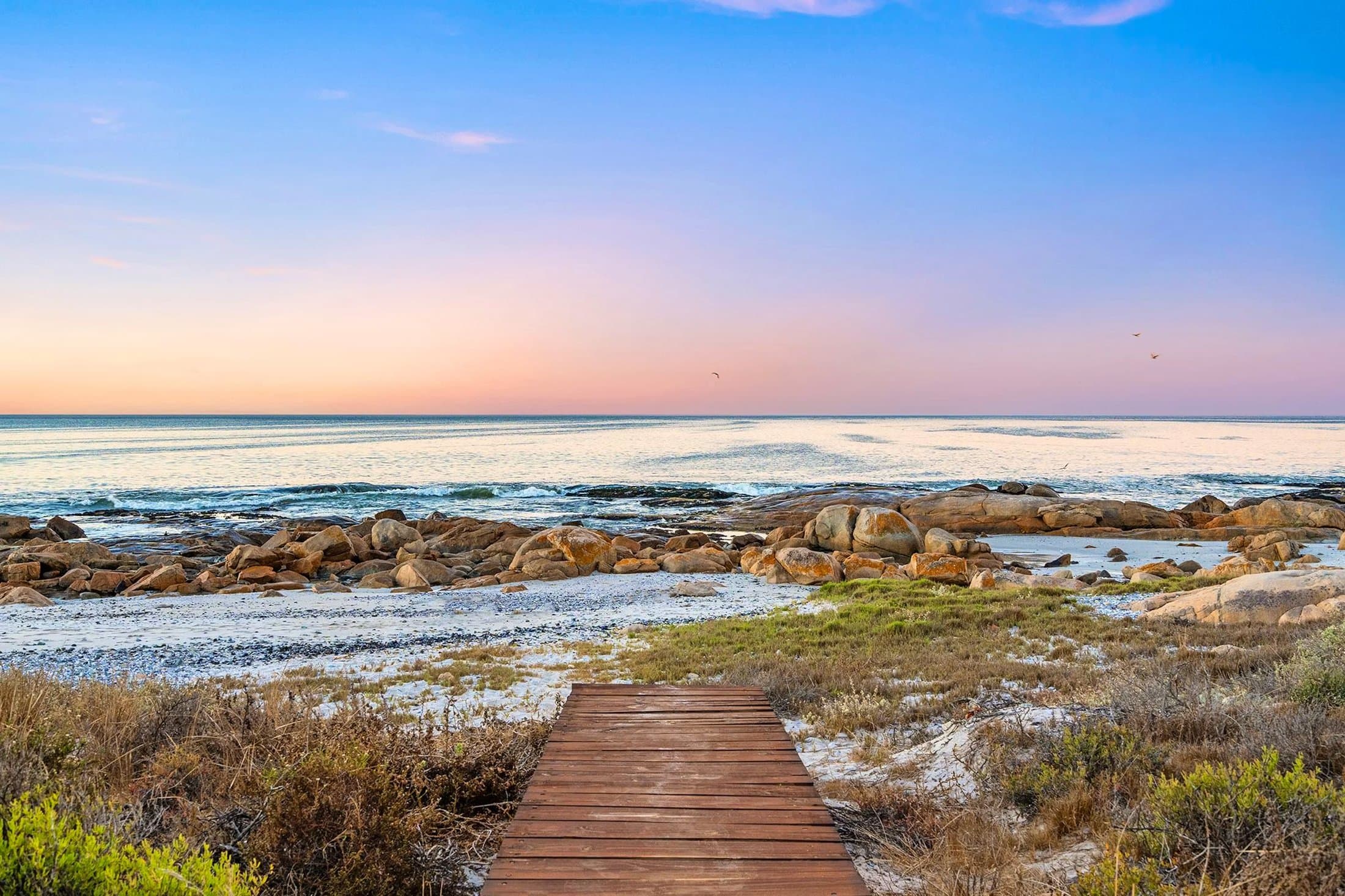 The private boardwalk from Villa View running down to the Atlantic at dusk