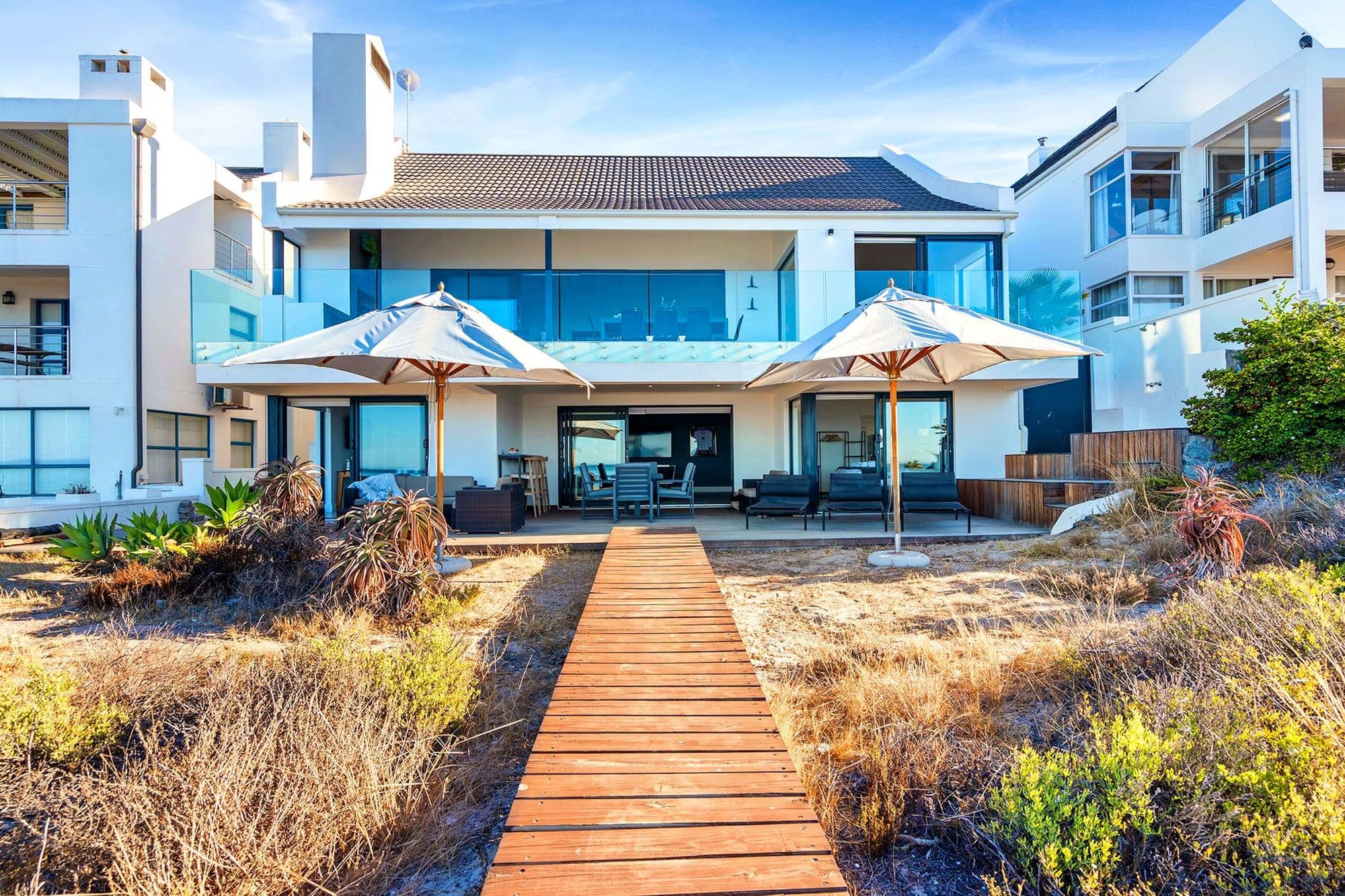 A private wooden boardwalk running from Villa View's patio straight onto the beach